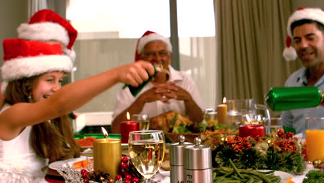 siblings pulling a christmas cracker at the dinner table