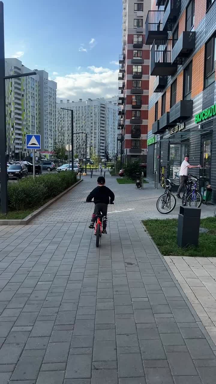 Child Riding a Bicycle in an Urban Area