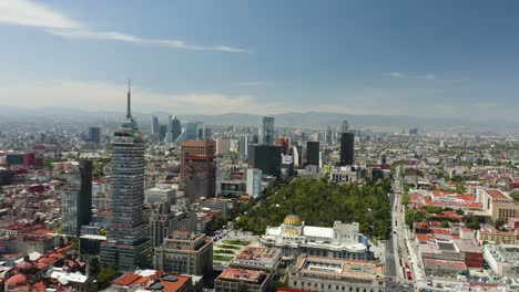 Drone-Circles-Over-Palacio-de-Bellas-Artes,-Torre-Latinoamericana,-Alameda-Central-in-Mexico-City,-Truck-Right