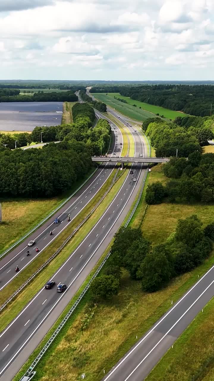 Aerial View of a Multi-Lane Highway Winding Through Green Countryside