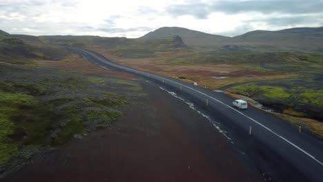 car driving in distance on country road in iceland