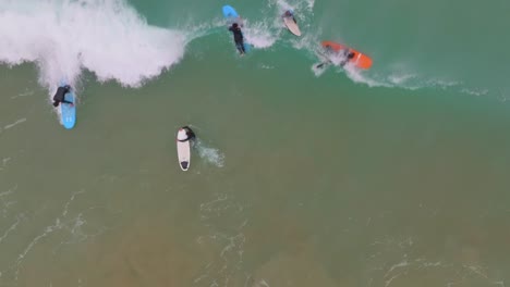 Slow-motion-top-down-view-of-surfer-bailing-as-wave-crashes-over-and-sucks-them