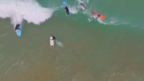 slow motion top down view of surfer bailing as wave crashes over and sucks them