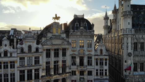 Aerial-forward-flying-from-Grand-Place-to-Belgian-beer-museum-Brussels-square-buildings-on-sunny-and-cloudy-day-of-January,-Belgium
