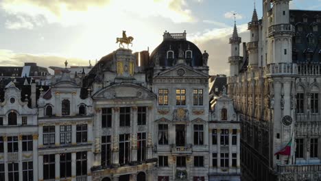 aerial forward flying from grand place to belgian beer museum brussels square buildings on sunny and cloudy day of january, belgium