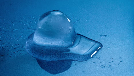 ice cube melting time-lapse with cold blue background