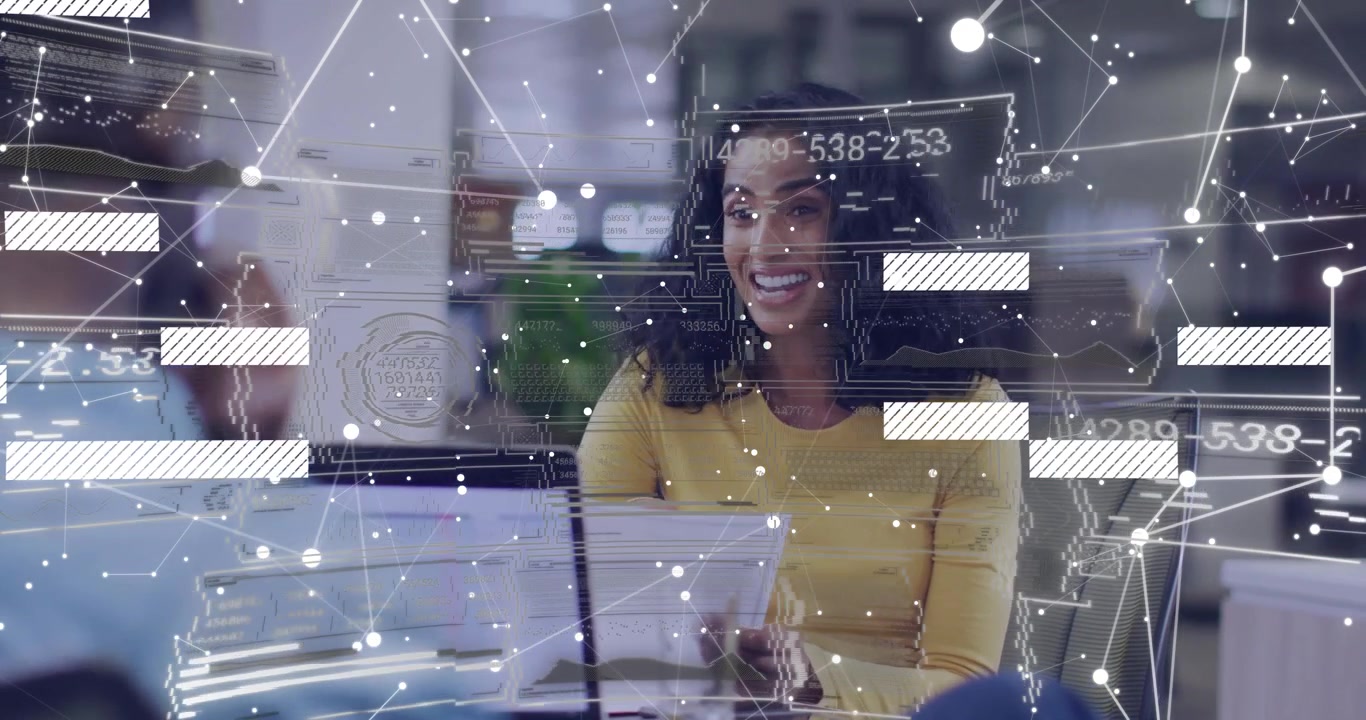 Woman sitting at desk with laptop taking file from peer and reading while network graphs overlaying
