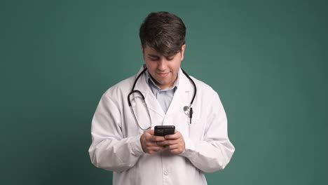 smile and doctor with smartphone for wellness research, medical app, on green background