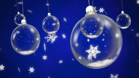 animation of baubles over snow falling on blue background