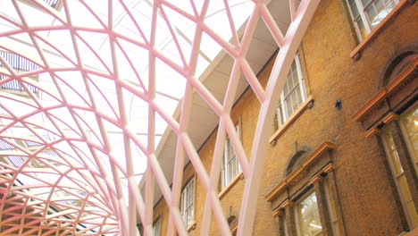 looking up into the roof of king's cross station with modern interior in london, united kingdom