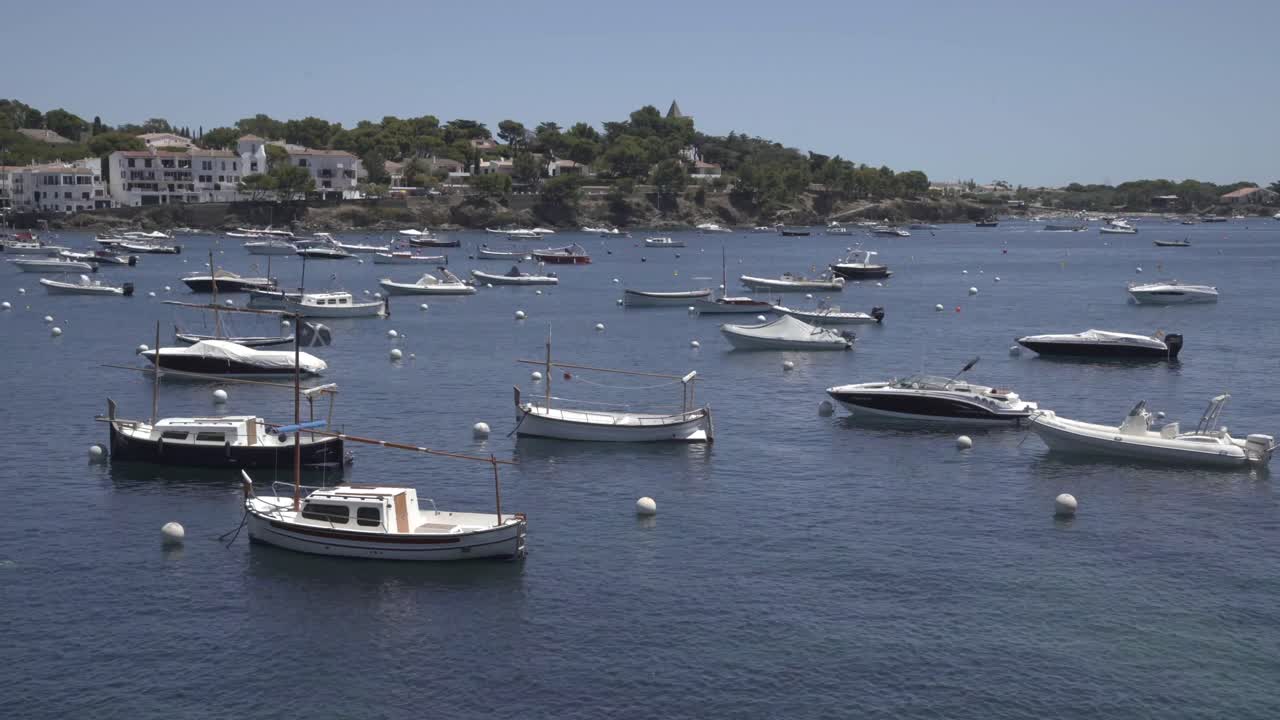 White boats in the ocean, coast town, Costa Brava, Spain, static shot