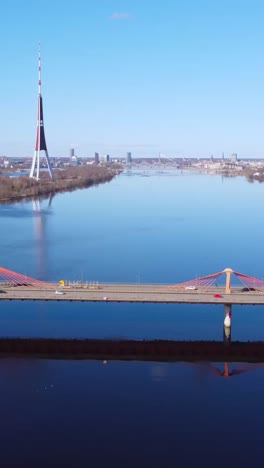 vertical aerial shot of southern bridge with tv tower, moving forward, riga