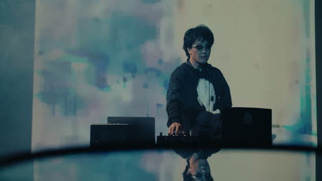music dj play on stage during a festival event in nightclub dancing on the beat