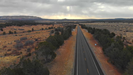 Majestic-Gods-Rays-Over-Distant-Mountain-with-Highway-Leading-Lines,-Aerial