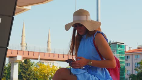 Caucasian-white-woman-sits-on-a-train-station-and-waits-for-the-next-train