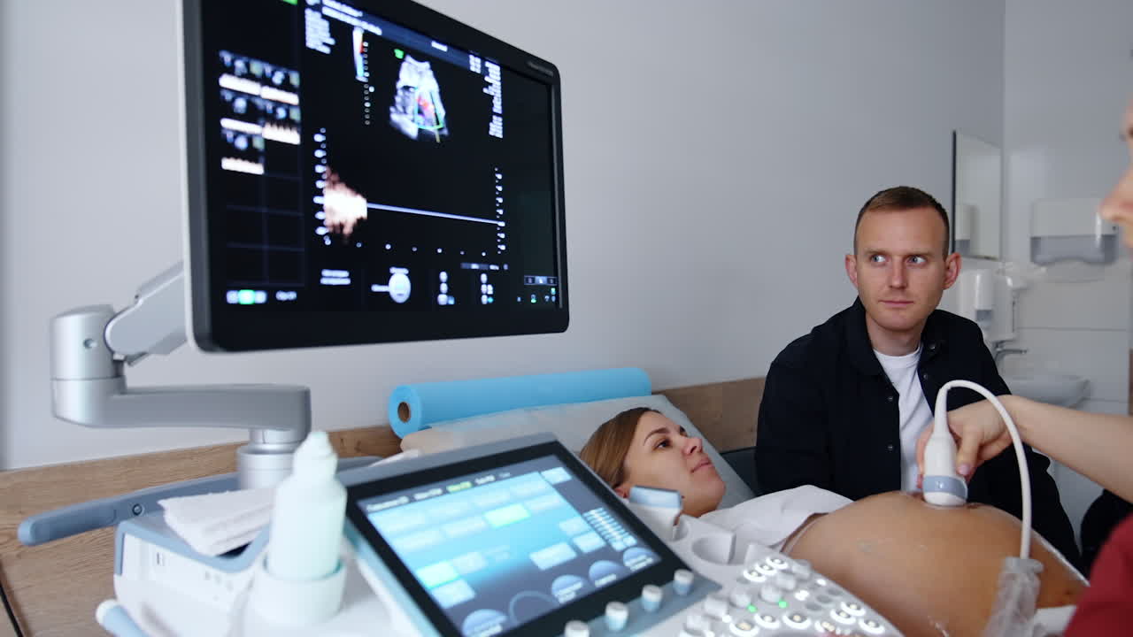 Ultrasound examination of a pregnant woman. Screen of equipment showing the prenatal image of a baby.