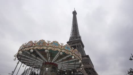 classic carousel under the eiffel tower in paris