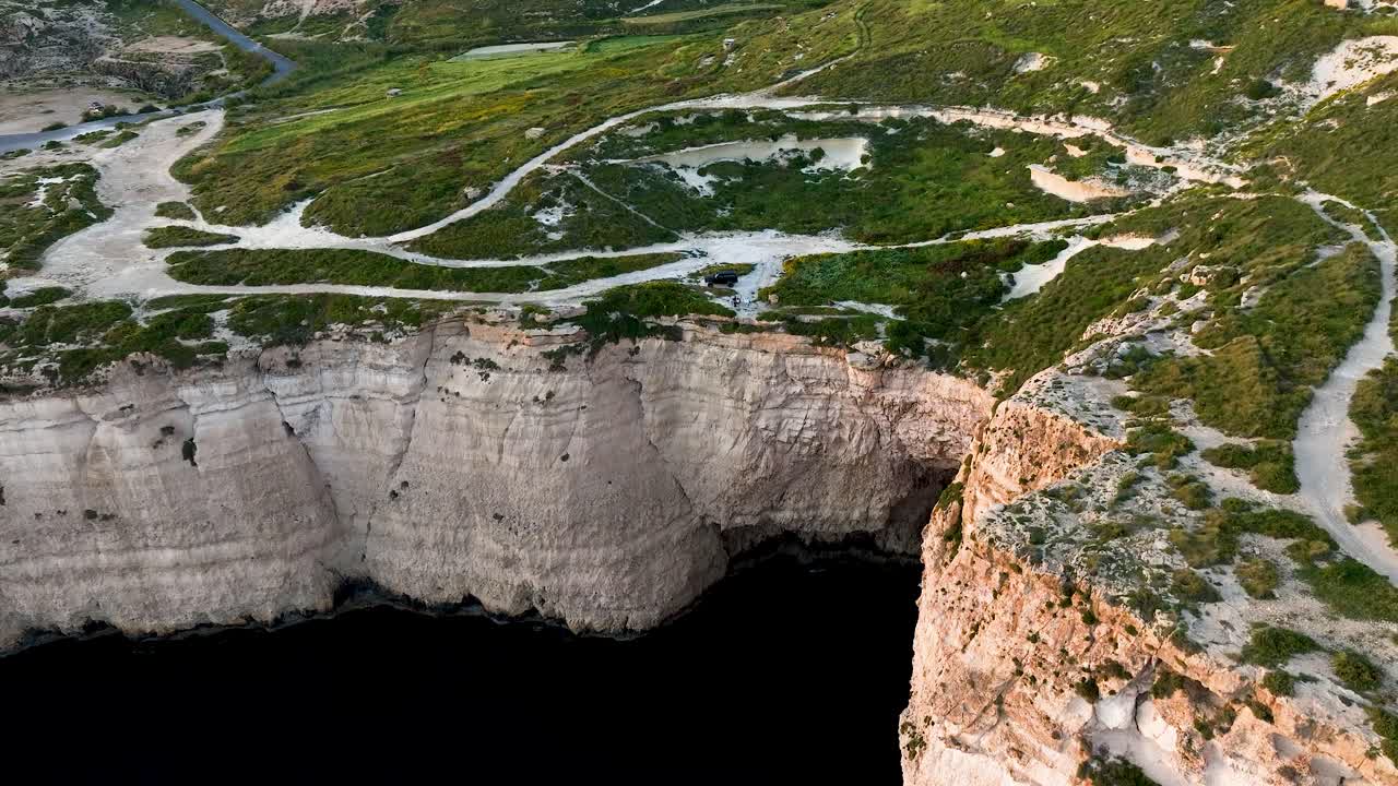 Soar above Miġra l-Ferħa’s breathtaking limestone cliffs and lush green fields, capturing Malta’s wild western coast and rugged Mediterranean landscape in stunning aerial detail.