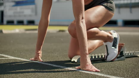 slow motion: woman athlete waits for start of race in 400 meters. girl athlete waits for start of race in 100 meters during. running at the stadium from the pads on the treadmill