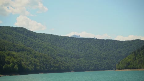 lake bicas and the peaks of the nearby carpathian mountains in western romania