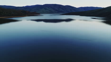 serene lake with mountain reflections at twilight