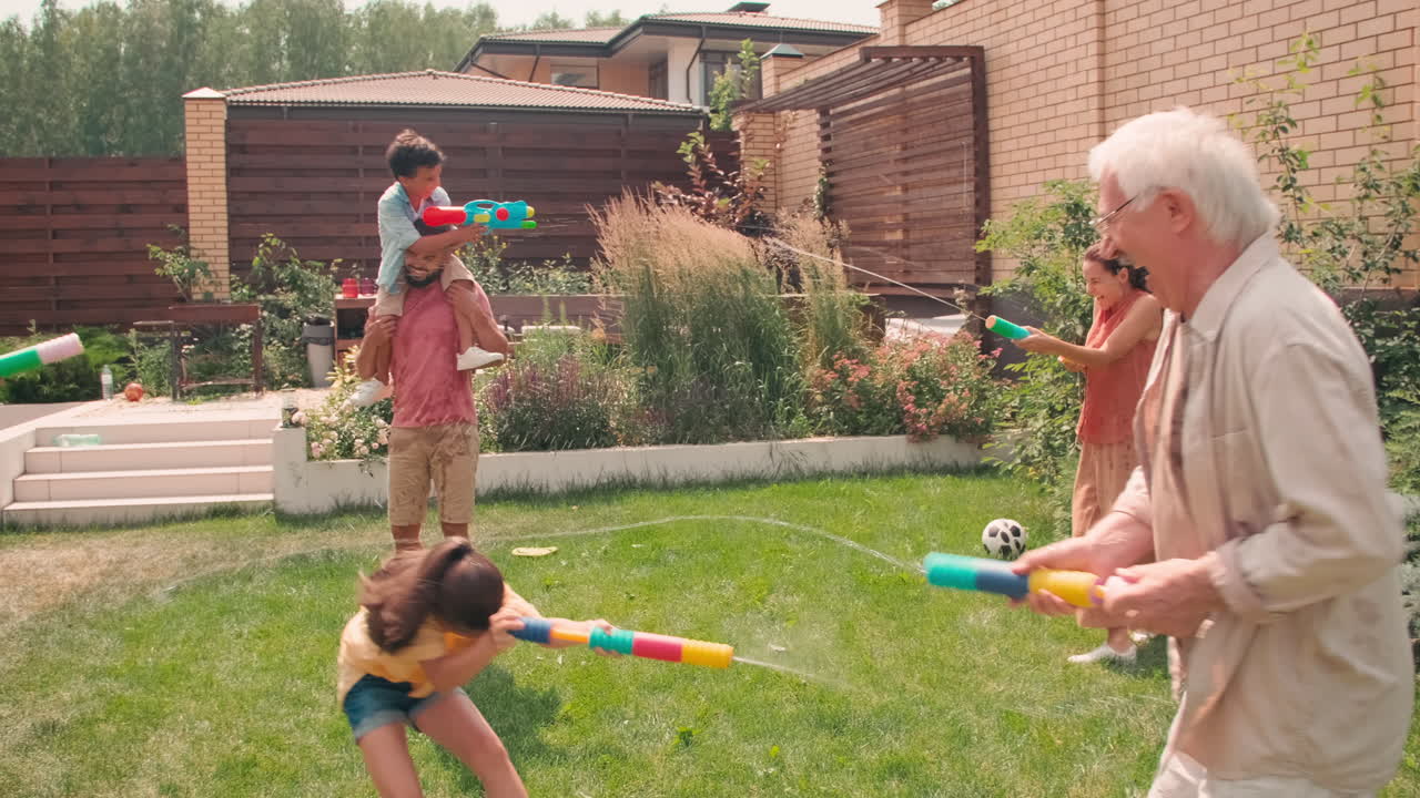 Sequence Of Joyful Big Family Shooting Water Guns