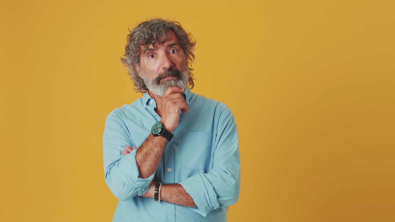 Mature Man Thinking and Then Showing Approval with Thumbs Up