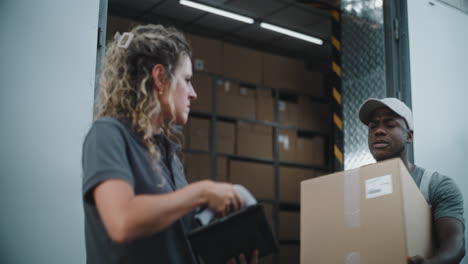 delivery workers checking packages from a truck