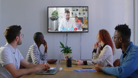 creative business colleagues in video conference in meeting room in modern office