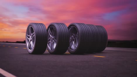 neumáticos de coche de bucle rodando sobre el asfalto en la puesta de sol