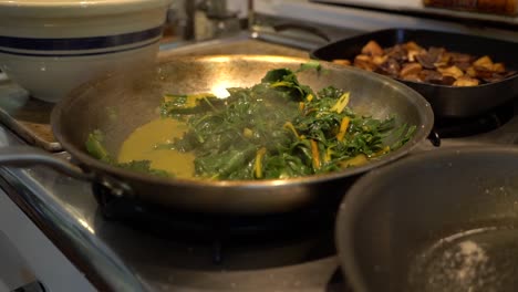 Vegetable-greens-simmer-in-a-pan.