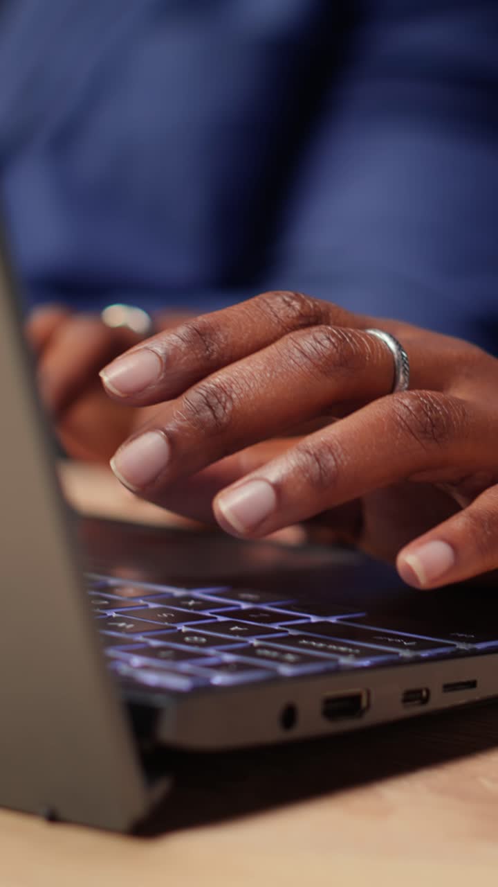 Close-up of Person's Hand Typing on Illuminated Laptop Keyboard