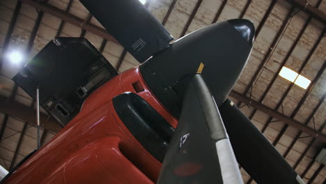 Propellor-plane-in-a-hangar-low-angle