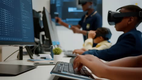 children engaged in vr and computer programming in a technology classroom