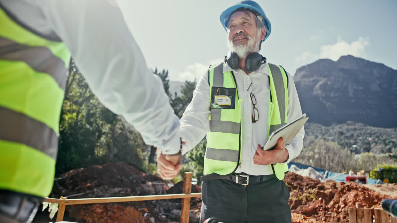 Construction engineers shaking hands