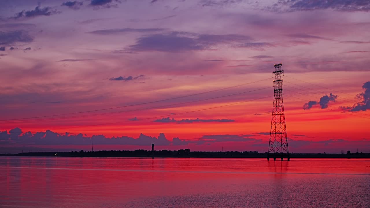 Vibrant dusk scene captures solitude and power across Latvian reservoir