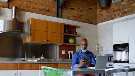 Senior-man-using-digital-tablet-in-kitchen-4k