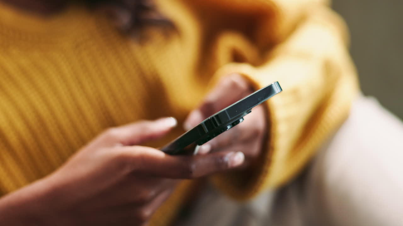 Hands holding and using a mobile phone