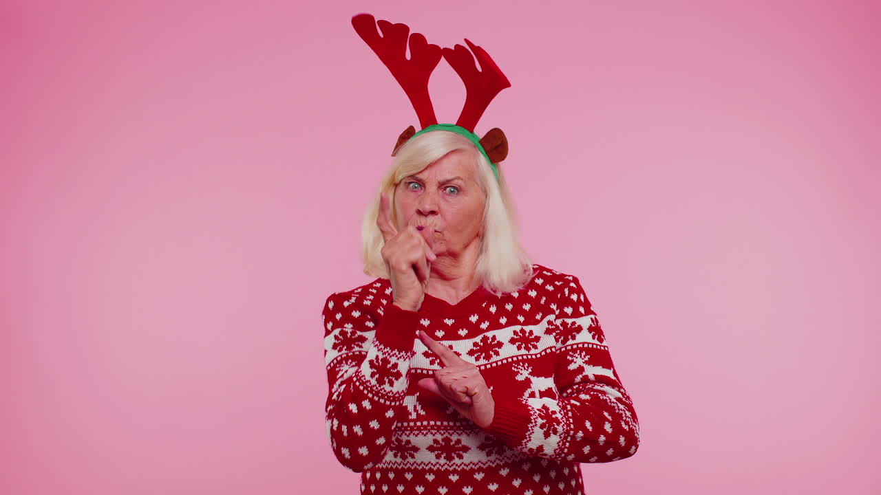 Displeased senior Christmas old woman gesturing hands with displeasure, blaming scolding for failure