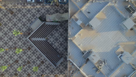 Top-down-view-The-old-city-hall-of-Bat-Yam-and-the-public-square-around-it,-The-building-built-between-1960-1963-and-was-exposed-to-the-coastline