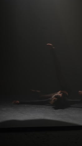 contemporary dance performance in a dark studio