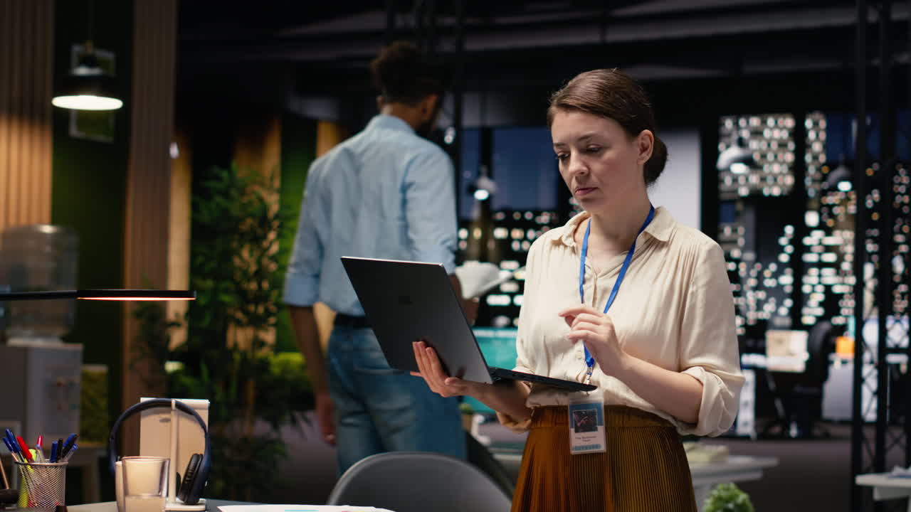 Portrait of smiling office employee managing schedules on laptop
