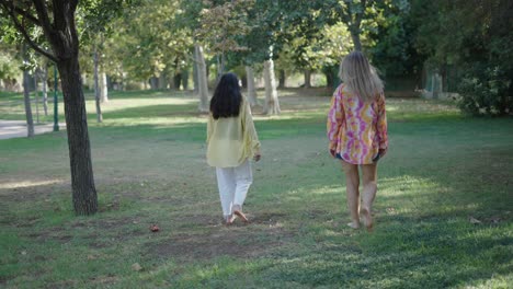 two women walking in a park
