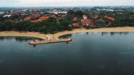 beautiful cinematic sanur beach, bali drone footage with interesting landscape, fishing boats and calm weather