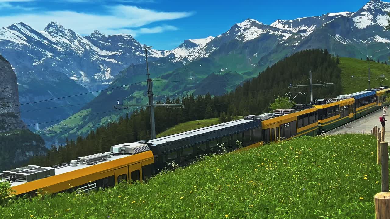 Kleine Scheidegg Trains Towards Jungfraujoch In The Bernese Oberland, Switzerland. Static Shot