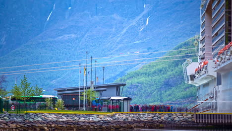 Cruiseship-tourists-offloading-at-Flam-harbor-in-Norway-fjord,-timelapse