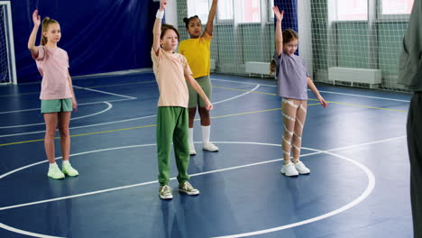 kids and trainer on the soccer field