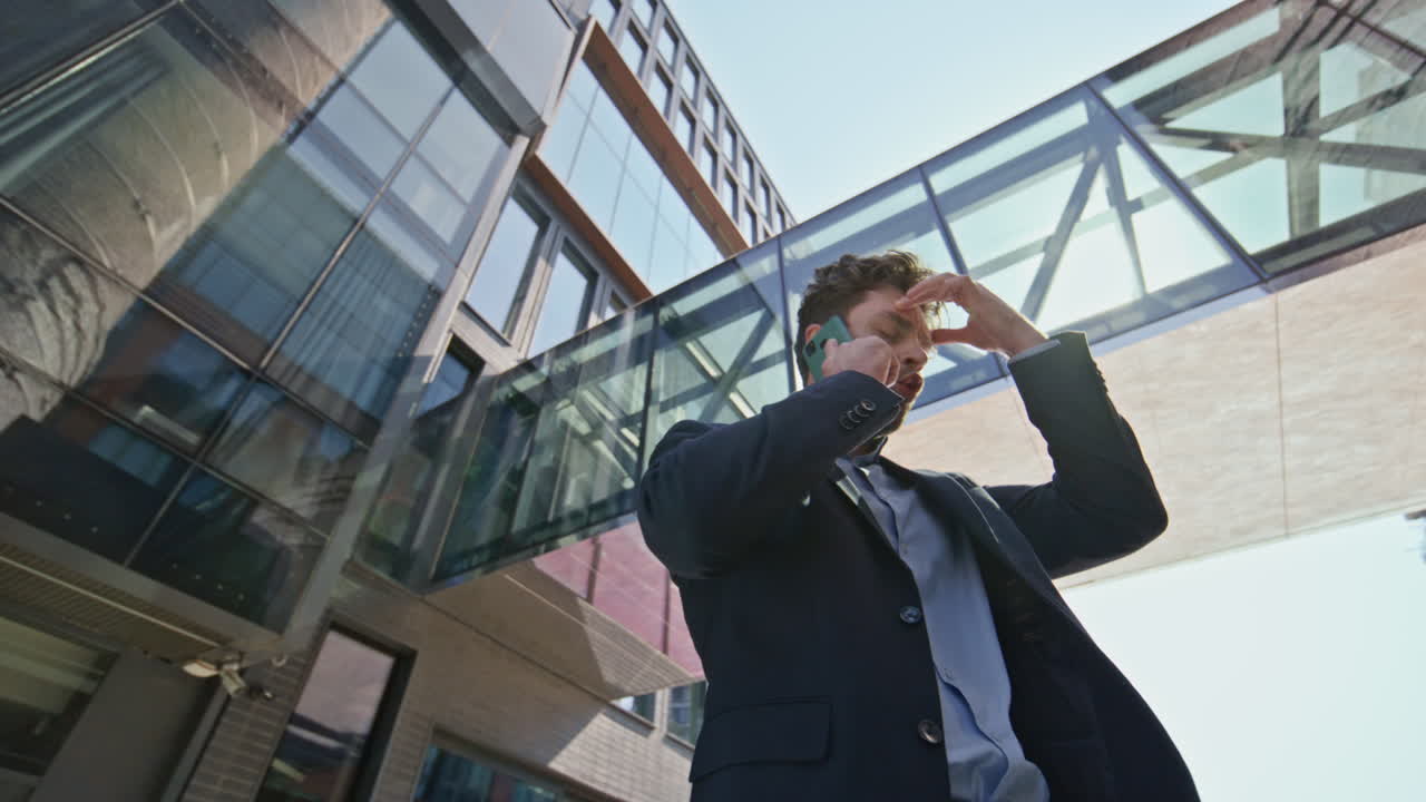 gerente molesto peleando por teléfono móvil en la calle urbana. hombre estresado llamando