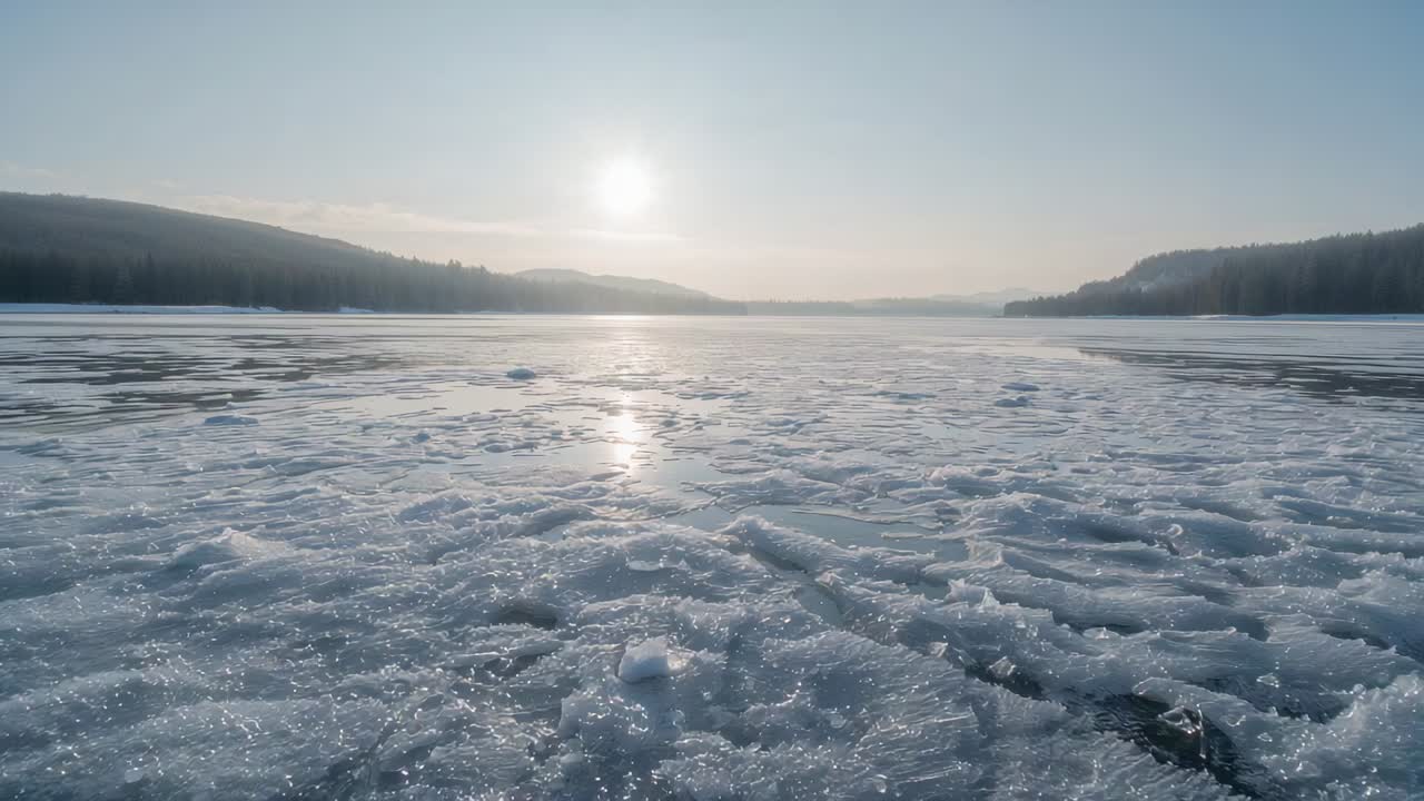 Shimmering frozen lake revealing fractured ice floes and dark water gaps under low sun, reflecting