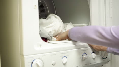 placing sheets into washing machine and closing machine